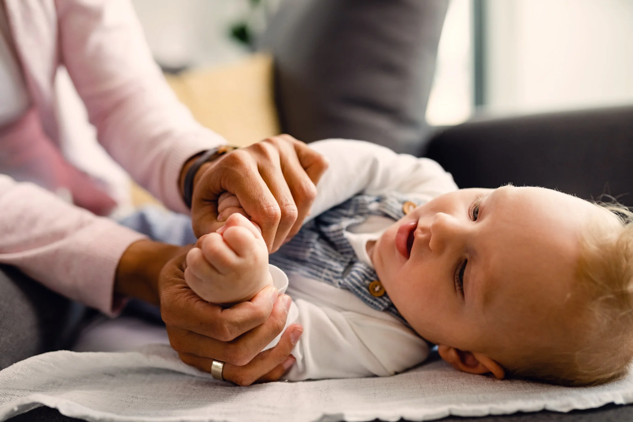 Newborn care specialist holding infant