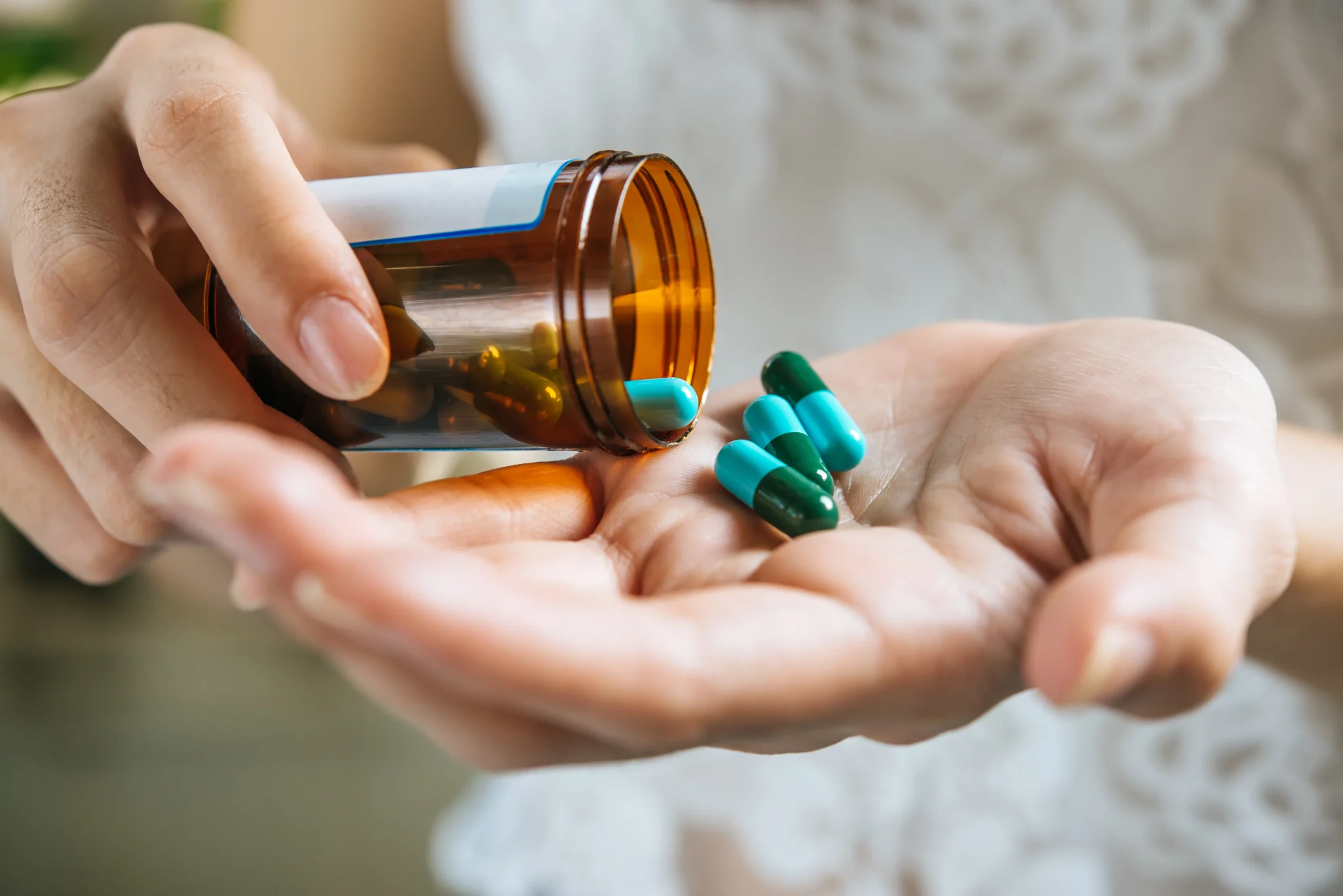 Caregiver organizing medications and providing reminders for senior