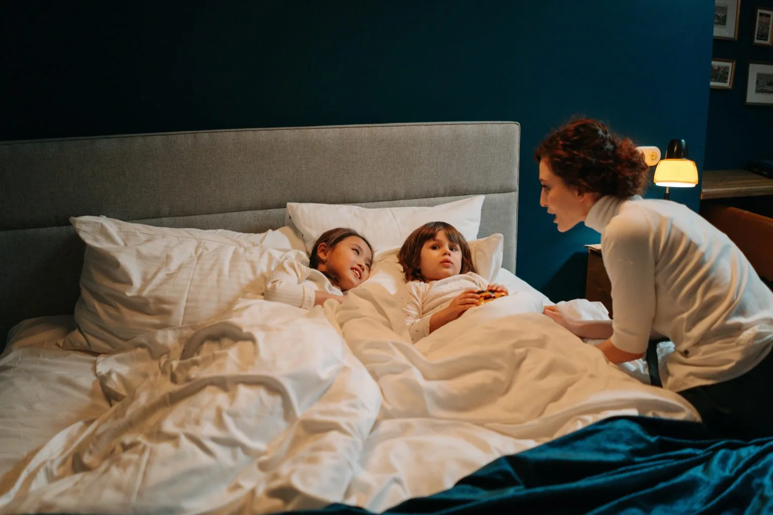 Hotel babysitter helping children settle into bedtime routine